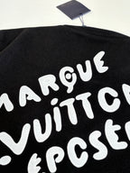 Louis Vuitton varsity jacket back graphic close-up, black with large white lettering.