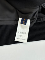 Black ribbed cuff with size M tag reading Made in Italy