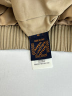 Beige jacket with inner label showing Made in Italy and Louis Vuitton branding
