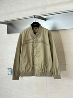 Tan bomber jacket with snap button front and ribbed V-neck collar