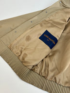 Beige long-sleeve jacket with button placket and Louis Vuitton chest patch