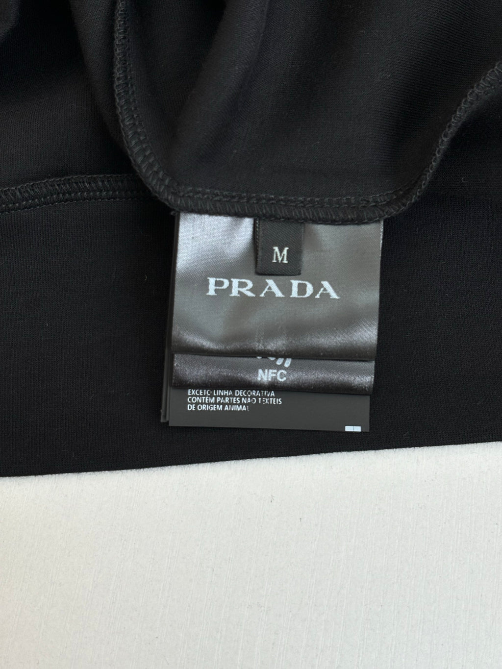Prada size label on inner collar, dark navy sweatshirt
