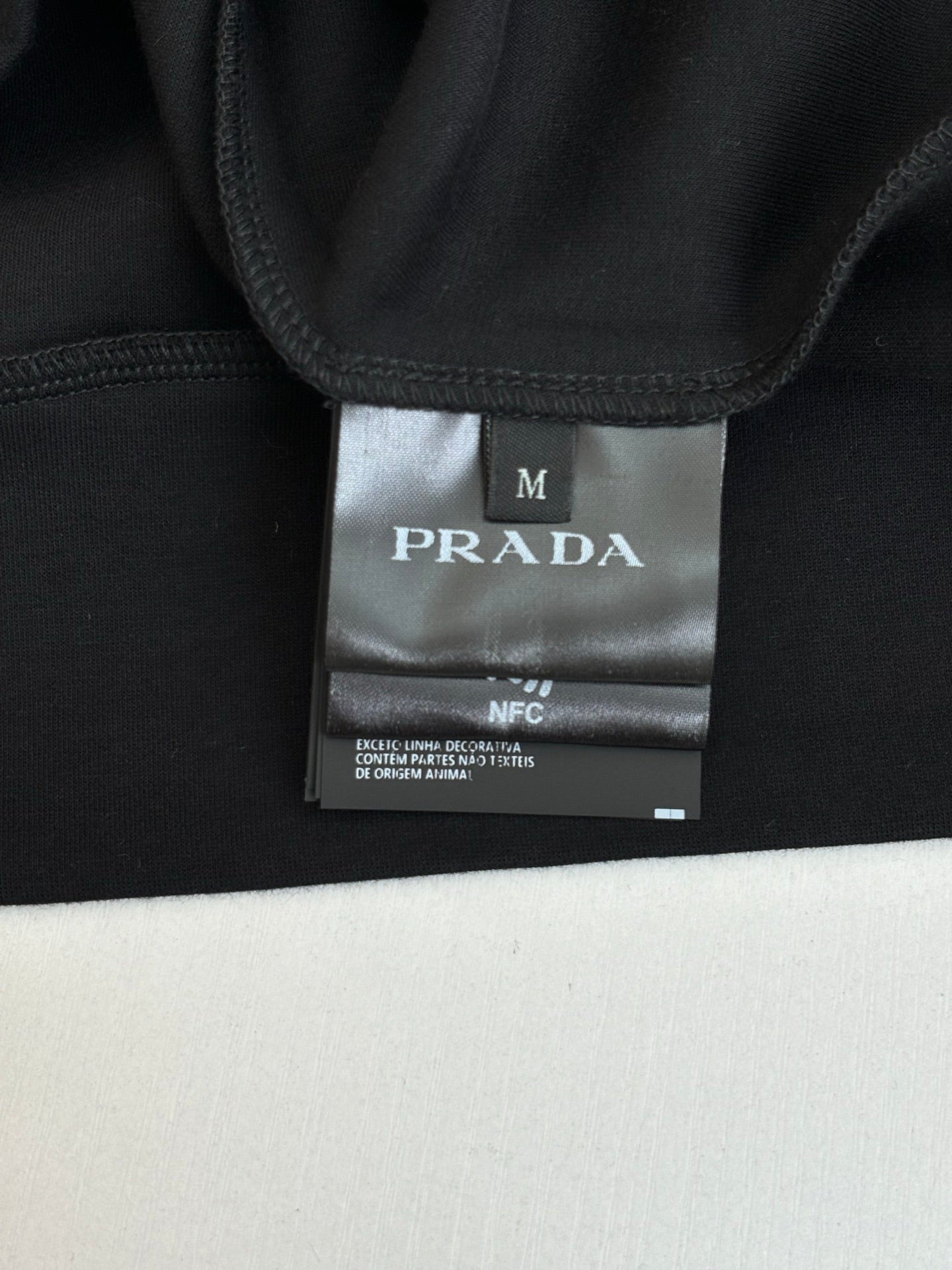 Prada size label on inner collar, dark navy sweatshirt