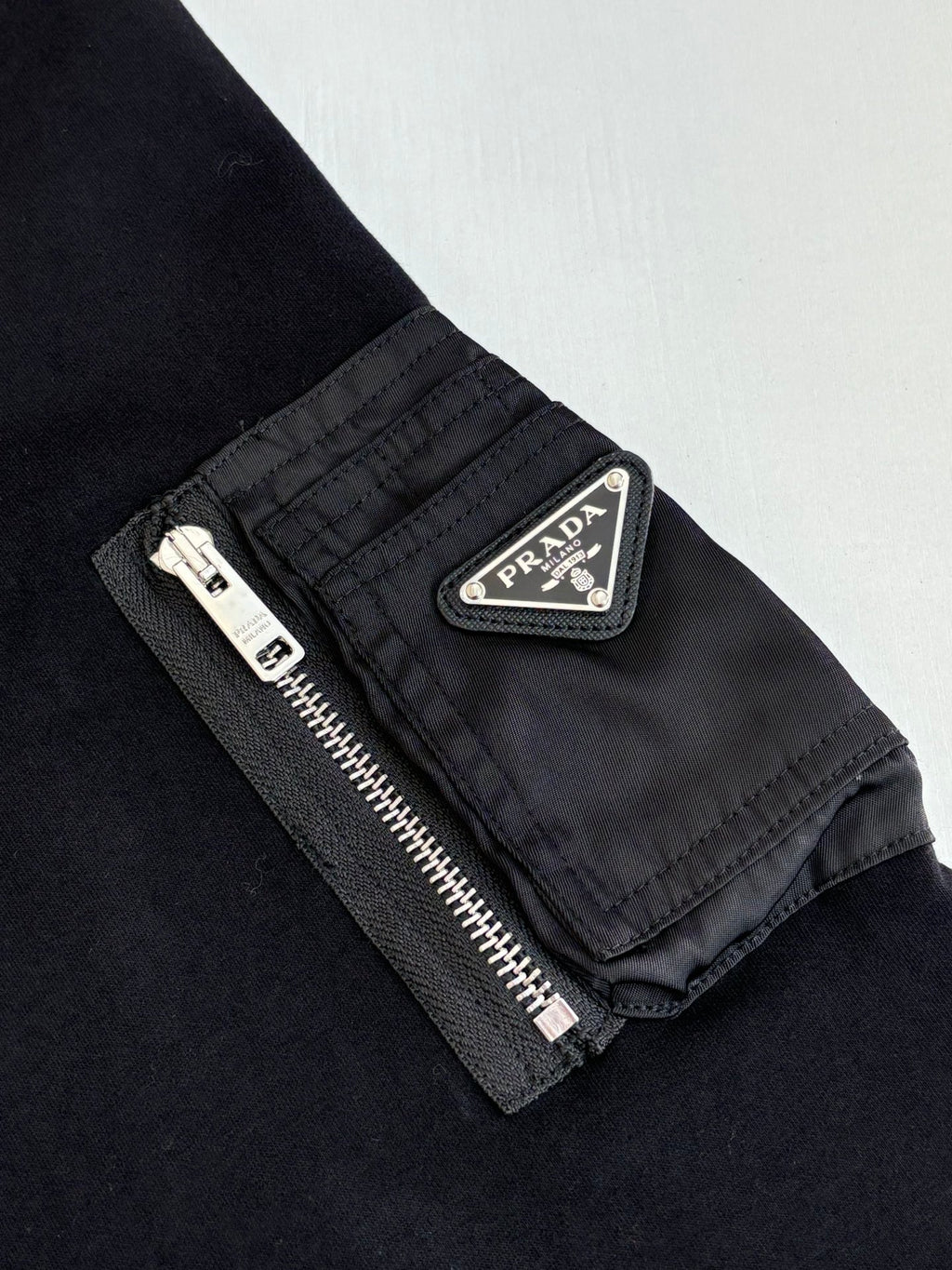 Prada logo patch on zipped sleeve pocket, dark navy sweatshirt