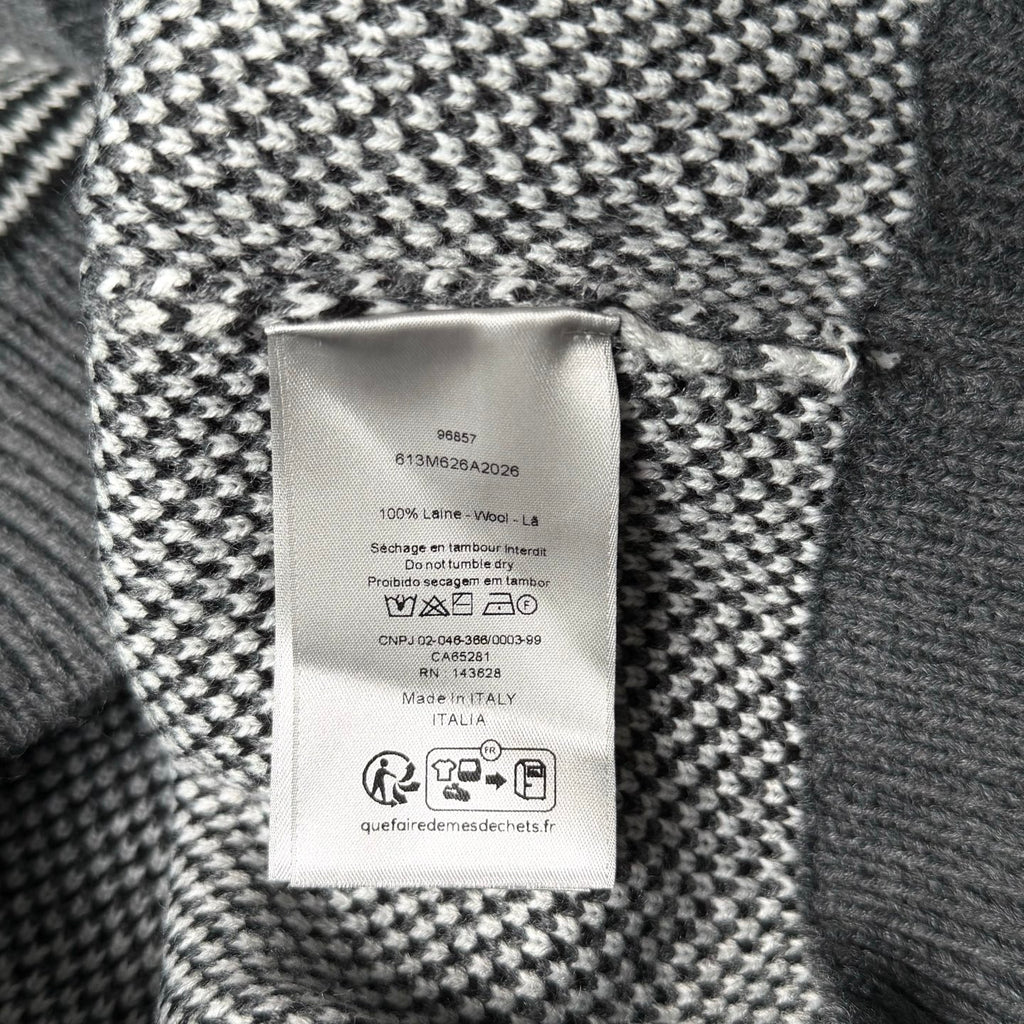Inside label on gray-and-white knit sweater with care and size information