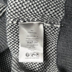 Inside label on gray-and-white knit sweater with care and size information
