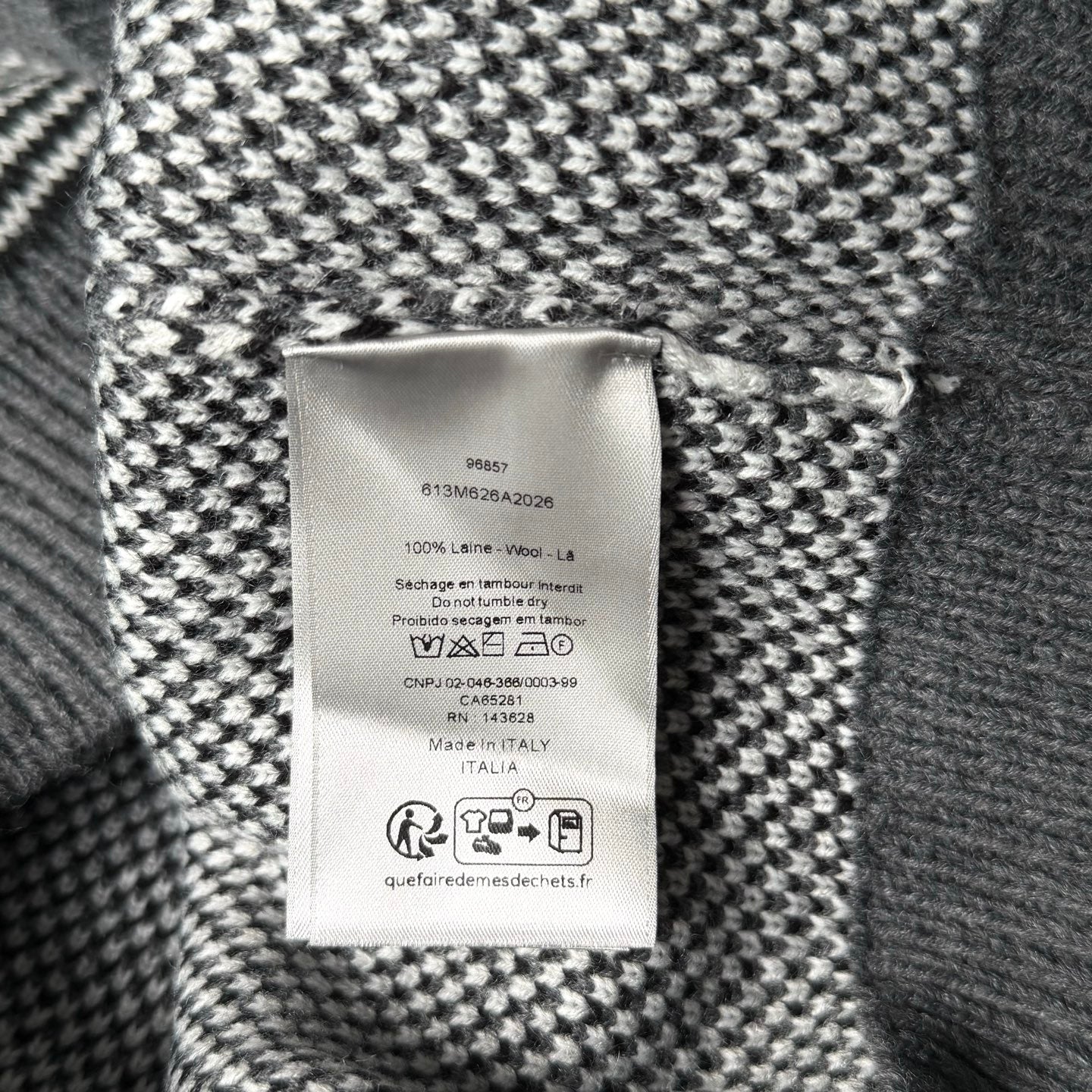 Inside label on gray-and-white knit sweater with care and size information