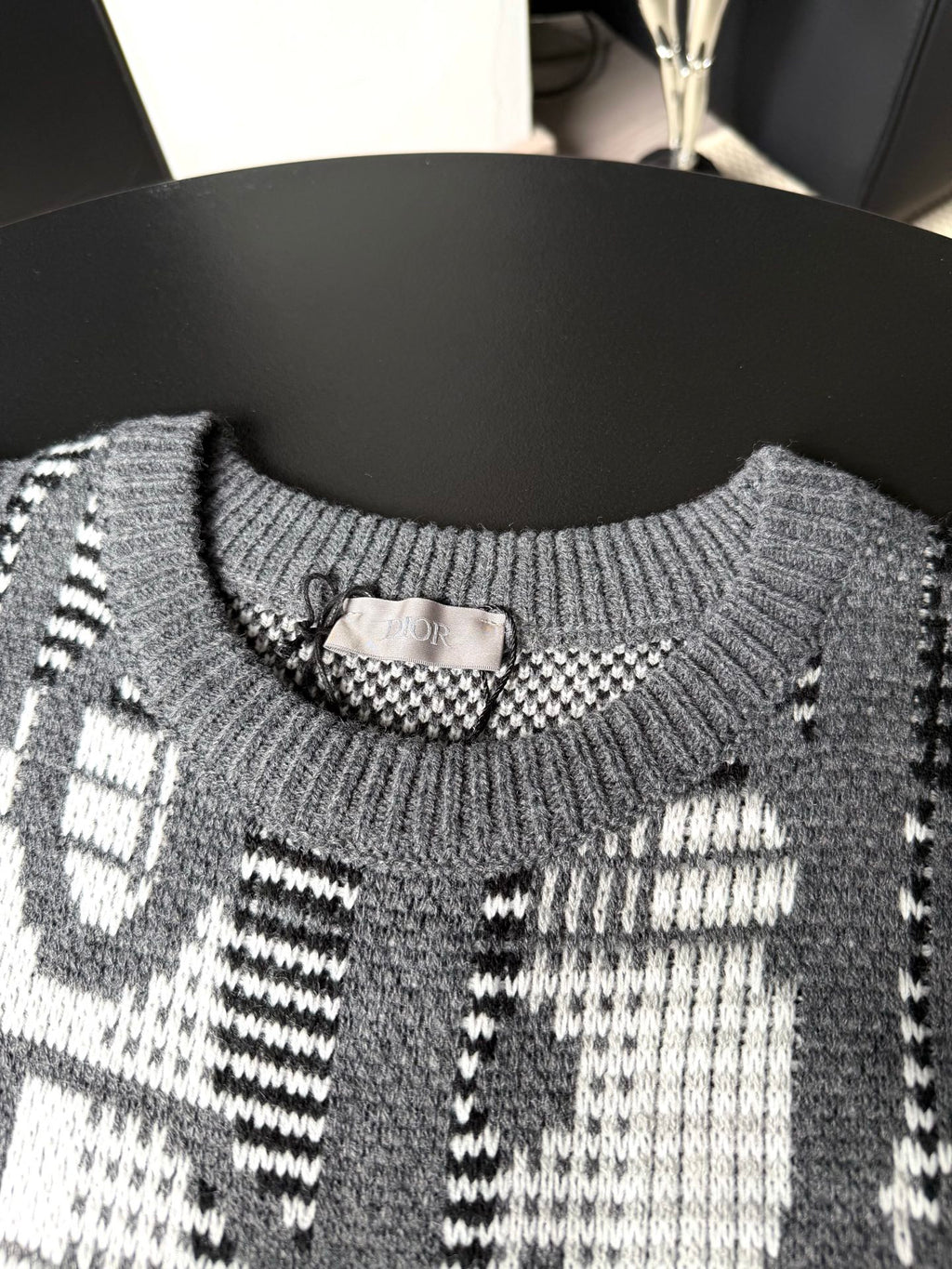 Gray sweater neckline with ribbed collar and black-and-white graphic knit pattern