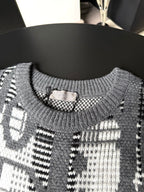 Gray sweater neckline with ribbed collar and black-and-white graphic knit pattern