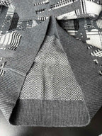 Gray sweater cuffs and hem with black-and-white knit pattern and ribbed trim