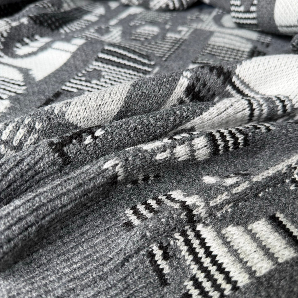 Gray knit fabric with black-and-white geometric and logo-style pattern