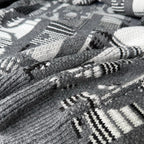 Gray knit fabric with black-and-white geometric and logo-style pattern