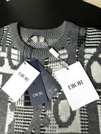 Gray knit sweater with black-and-white logo pattern and Dior hang tags