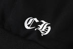 Black hoodie sleeve close-up of white embroidered logo patch.