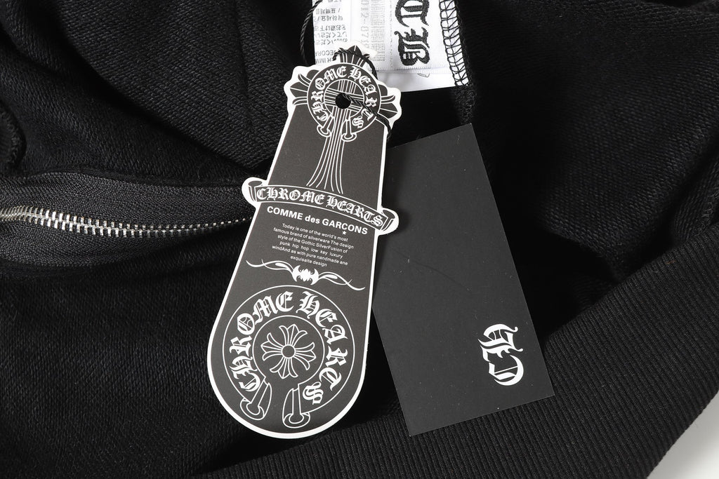 Black long-sleeve top with dangling brand hang tag