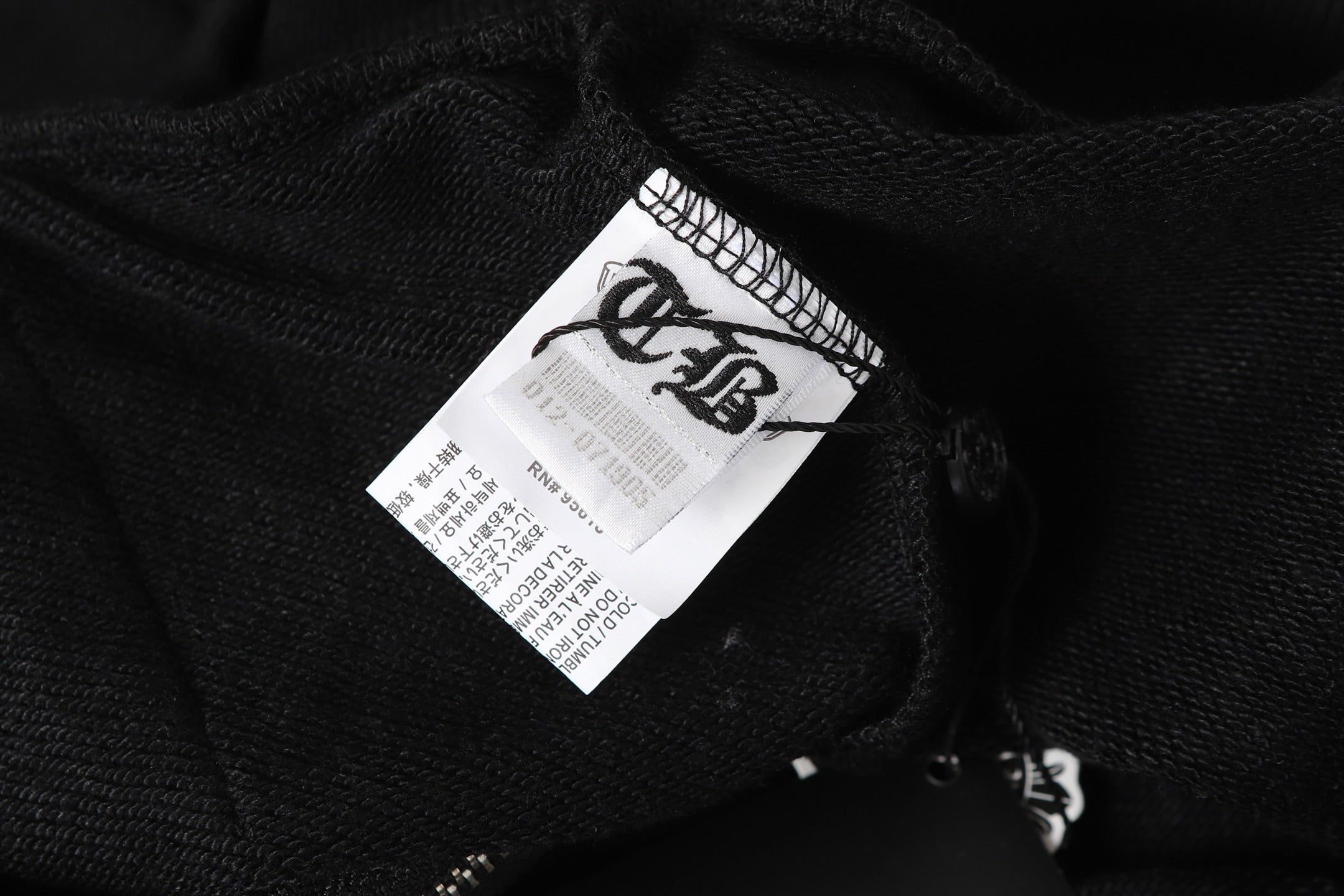Black long-sleeve top neckline with size label