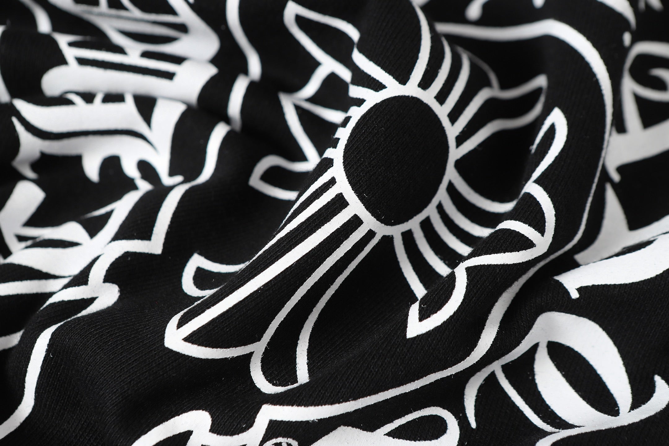 Black long-sleeve top with white floral graphic print