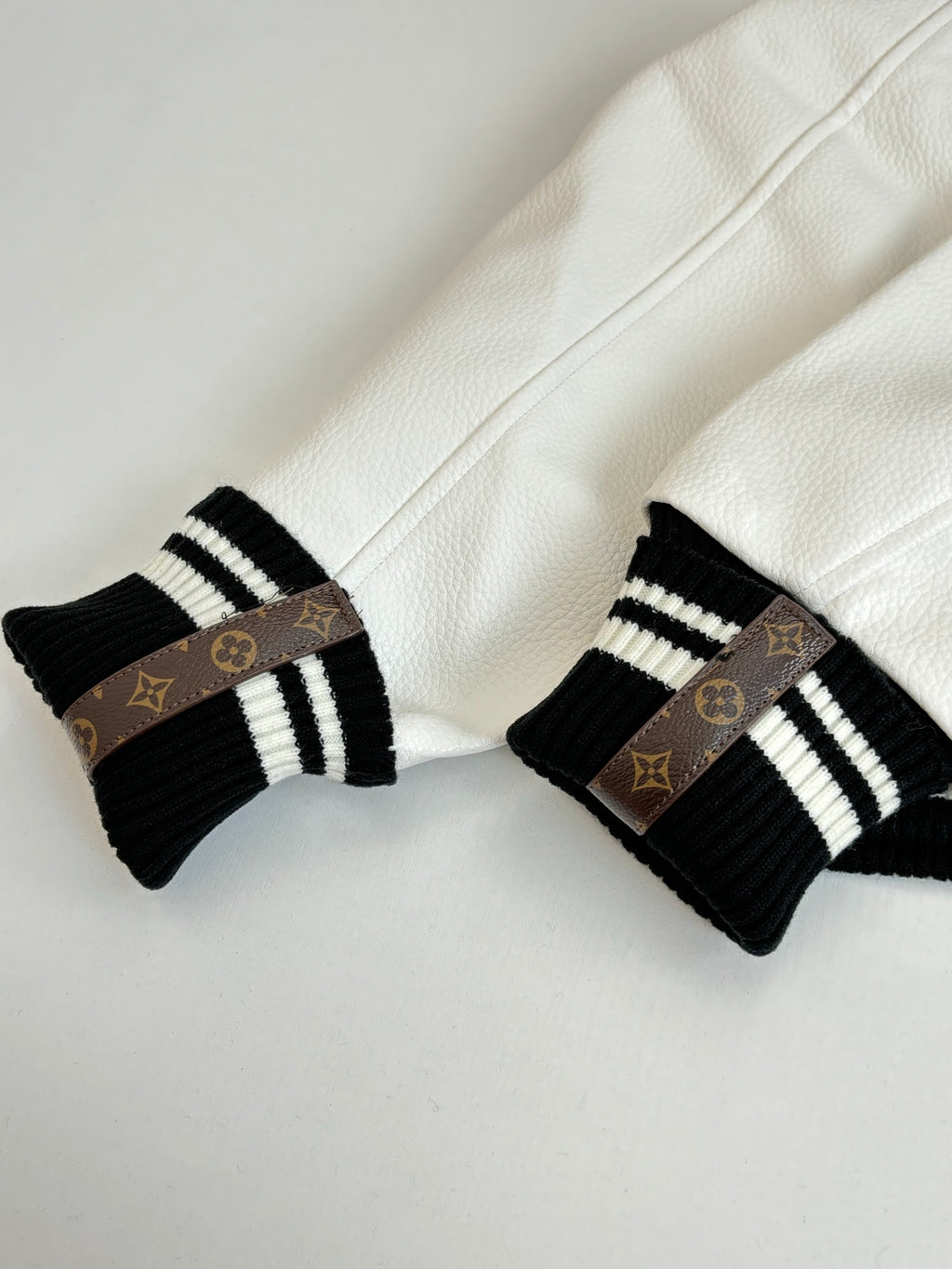Louis Vuitton knit cuff details, black-and-white striped rib with monogram band