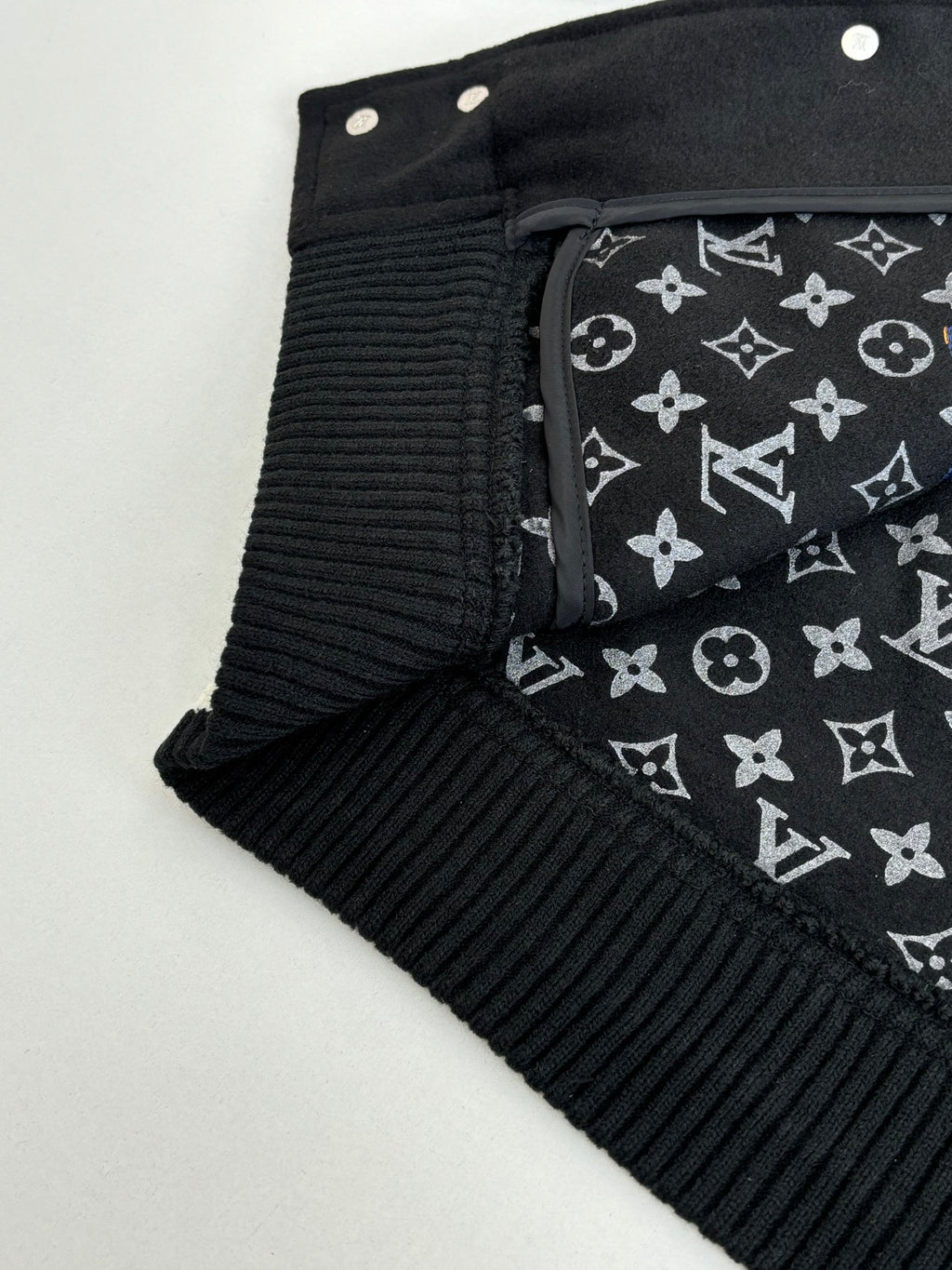 Louis Vuitton varsity jacket cuff and collar with black lining featuring repeating monogram pattern
