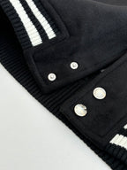 Louis Vuitton varsity jacket hem and button placket close-up with ribbed striped details
