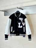 Louis Vuitton varsity jacket with black body, white sleeves, snap buttons, striped cuffs