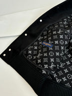 Louis Vuitton varsity jacket hood area with black fabric lining and repeating monogram print