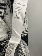 Givenchy clothing care label on white-and-black patterned knit sweater
