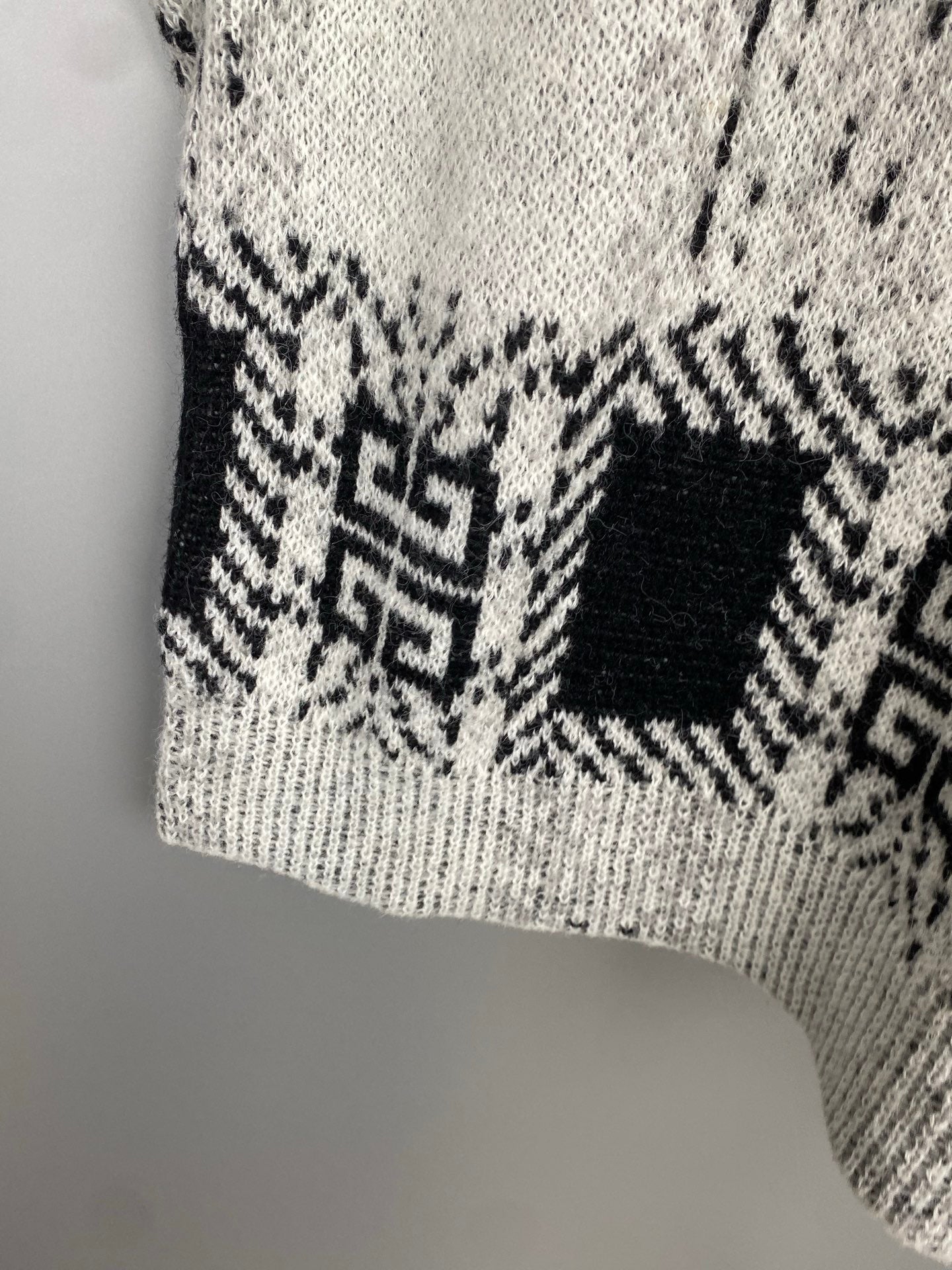 Givenchy knit sweater lower front section in black and white geometric pattern
