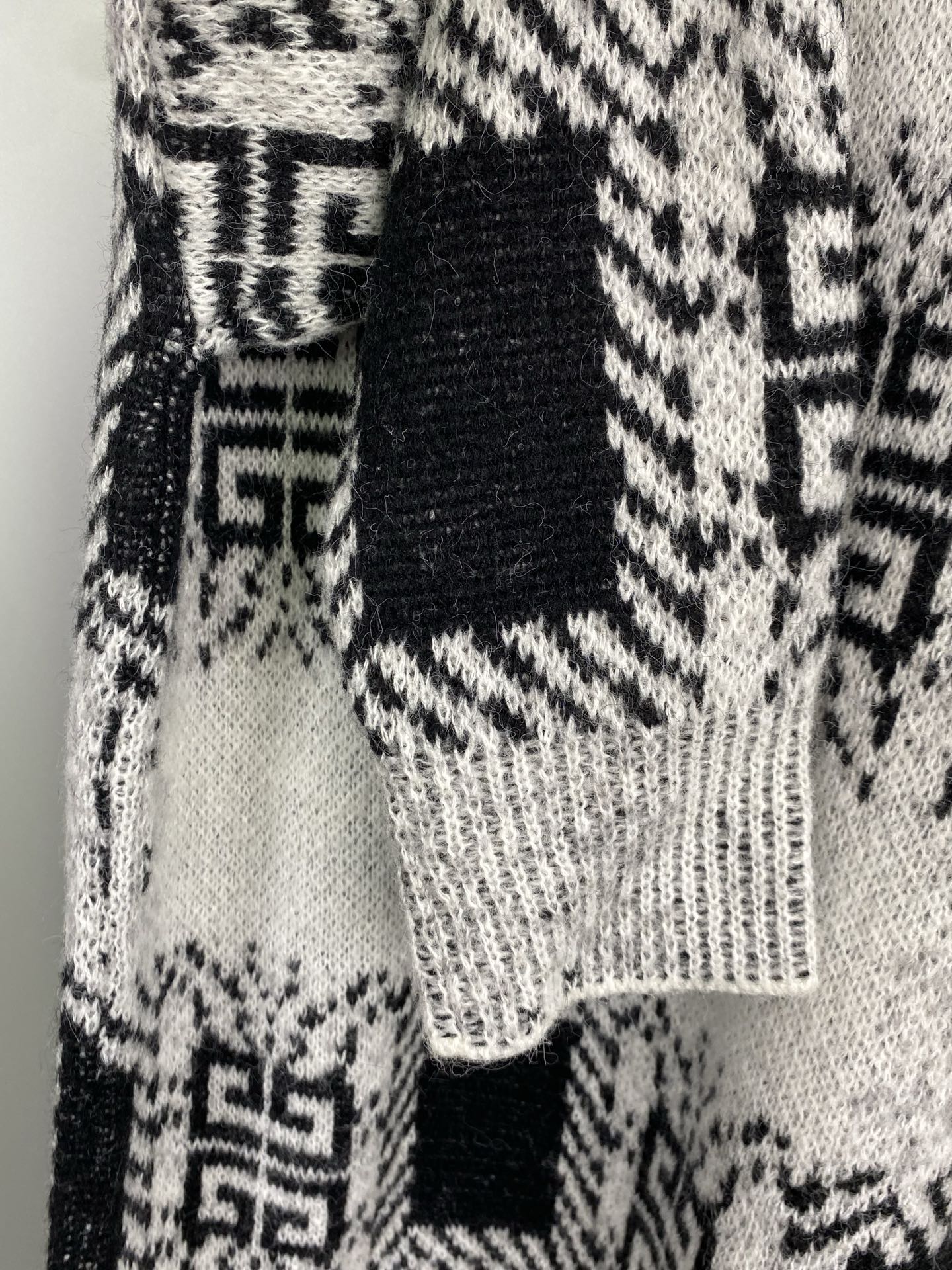 Givenchy knit sweater hem and sleeve with black-and-white geometric pattern knit