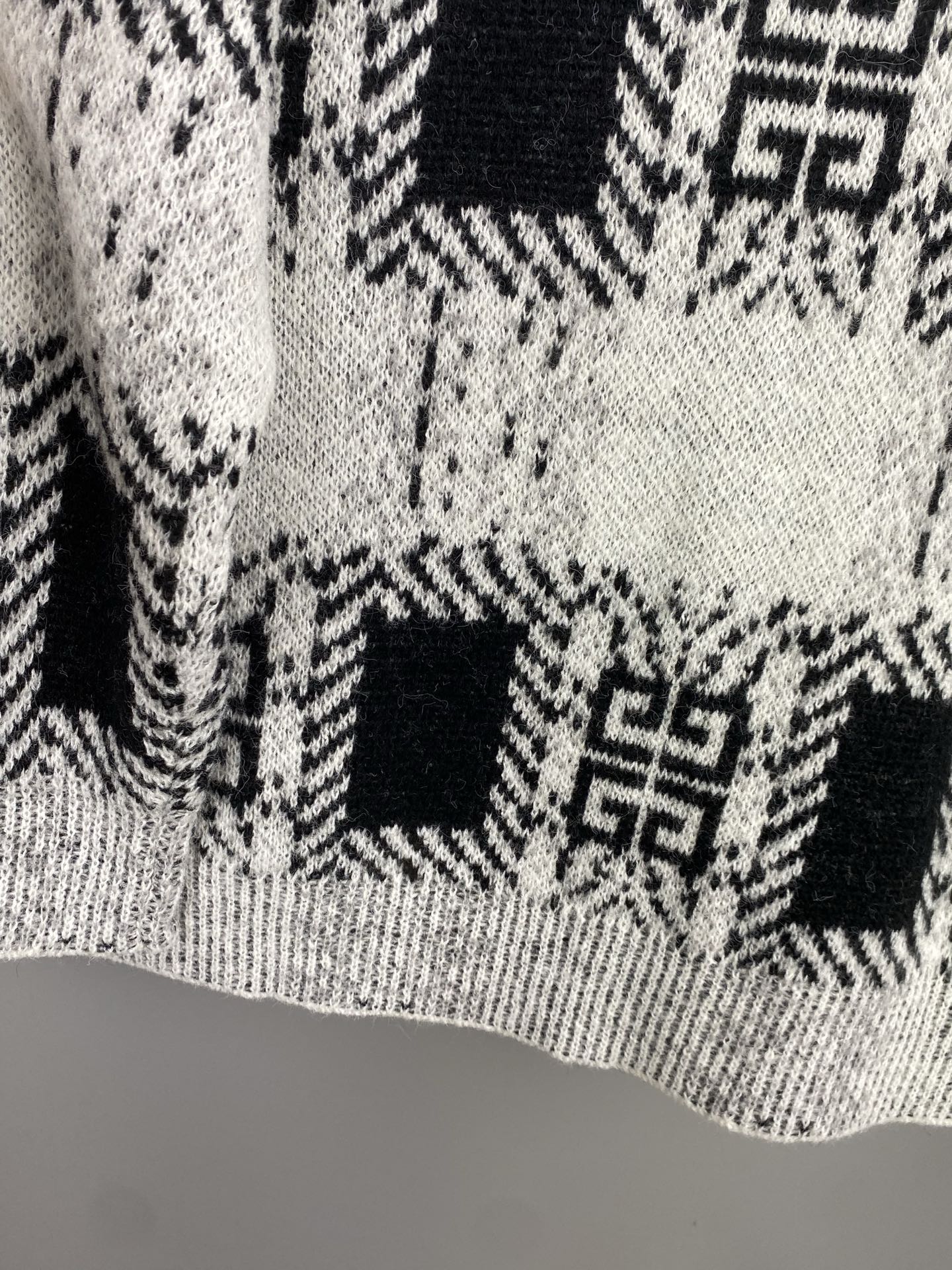 Givenchy knit sweater midsection with black-and-white geometric squares pattern