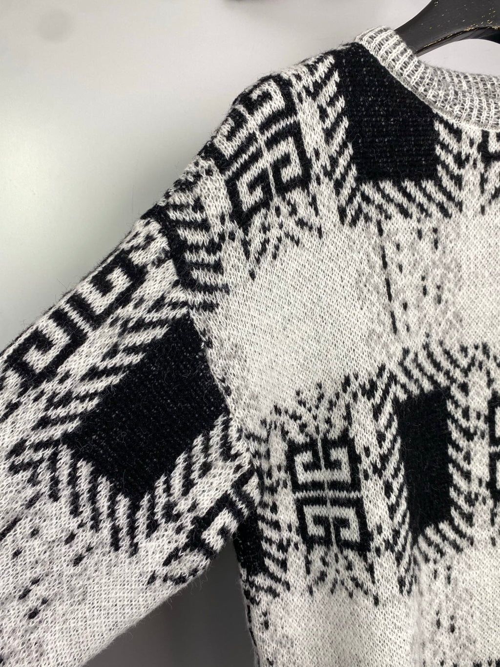 Givenchy knit sweater sleeve and shoulder with black-and-white geometric knit pattern