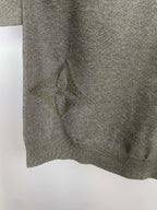 Grey knit sweater hem with subtle allover logo pattern, close-up