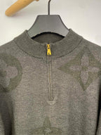 Grey knit zip sweater with yellow zipper pull and ribbed collar, close-up
