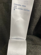 Clothing care label reading 100% coton, inside seam at grey knit sweater