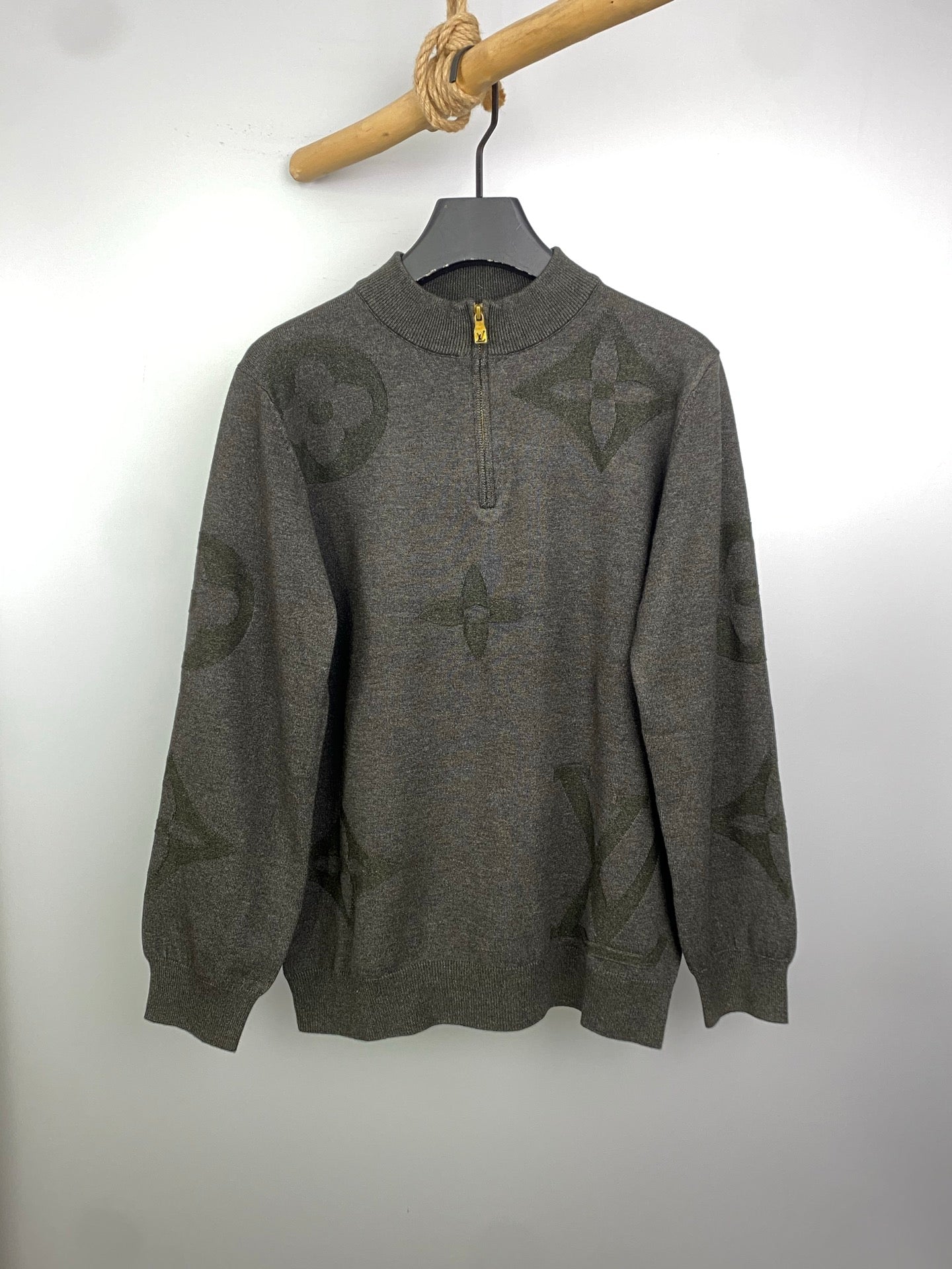 Grey knit zip sweater with allover logo pattern, ribbed cuffs and hem, on hanger