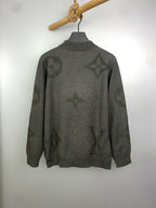 Grey knit zip sweater with logo pattern, standing collar style, on hanger