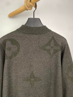 Grey knit zip sweater back view with allover logo pattern and ribbed collar