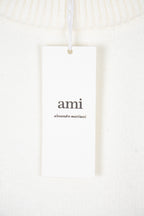 White knit sweater with ami brand hangtag