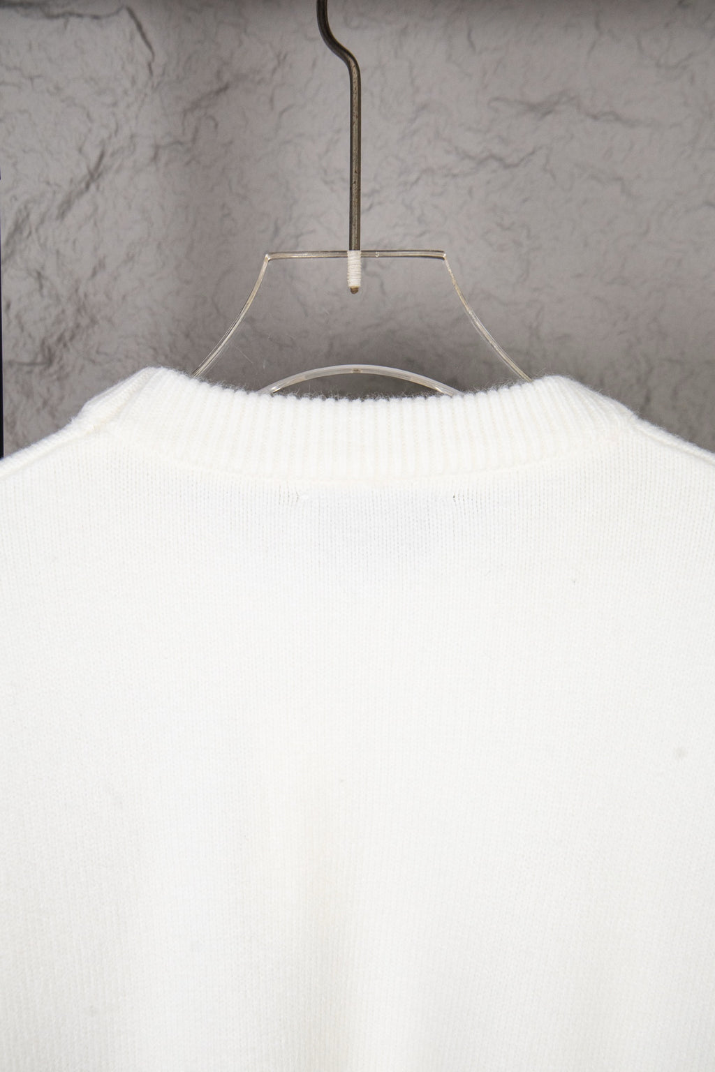 White knit sweater back view with ribbed collar and knit texture