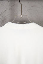 White knit sweater back view with ribbed collar and knit texture