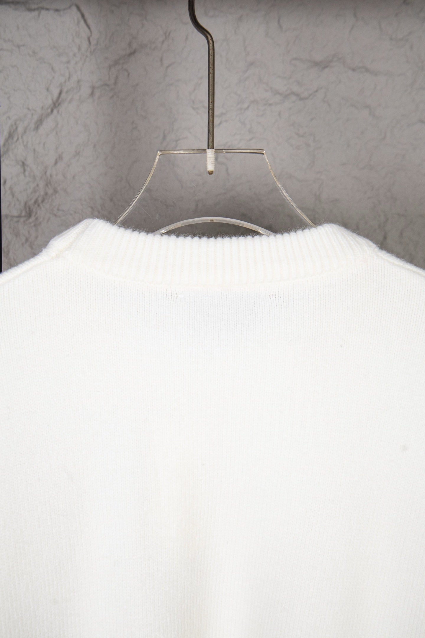 White knit sweater back view with ribbed collar and knit texture