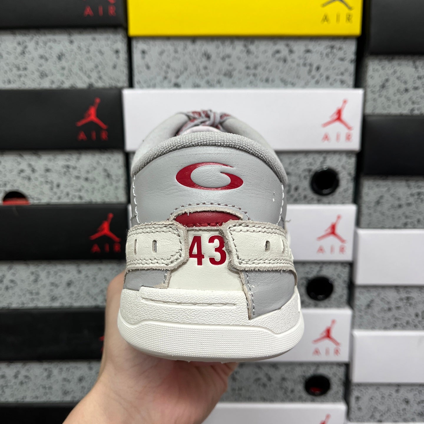 Back view of white sneaker with red heel mark and '43' label
