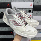 Angled view of white Balenciaga sneaker with red laces and red side logo stripe