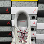 White sneaker interior view with gray collar and red lace pattern