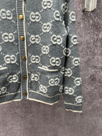 Gucci dark green knit cardigan with GG logo pattern and front button placket; ribbed hem.