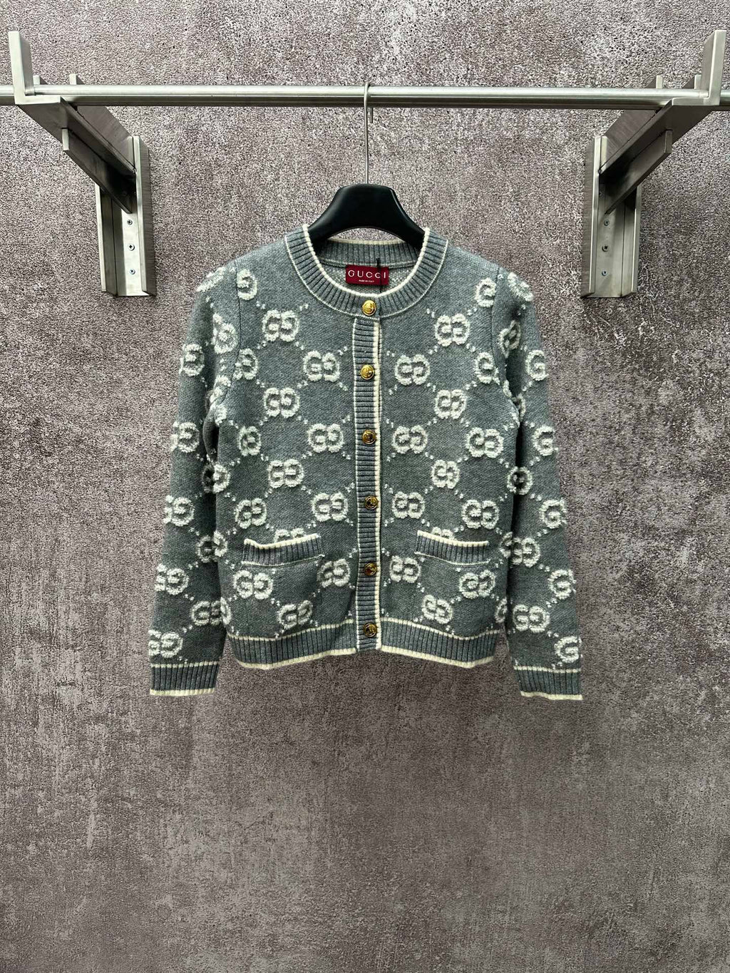Gucci cardigan sweater in dark green with repeating GG logo pattern and front zip.