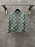 Gucci cardigan sweater in dark green with repeating GG logo pattern and front zip.
