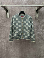 Gucci cardigan sweater in dark green with repeating GG logo pattern and front zip.