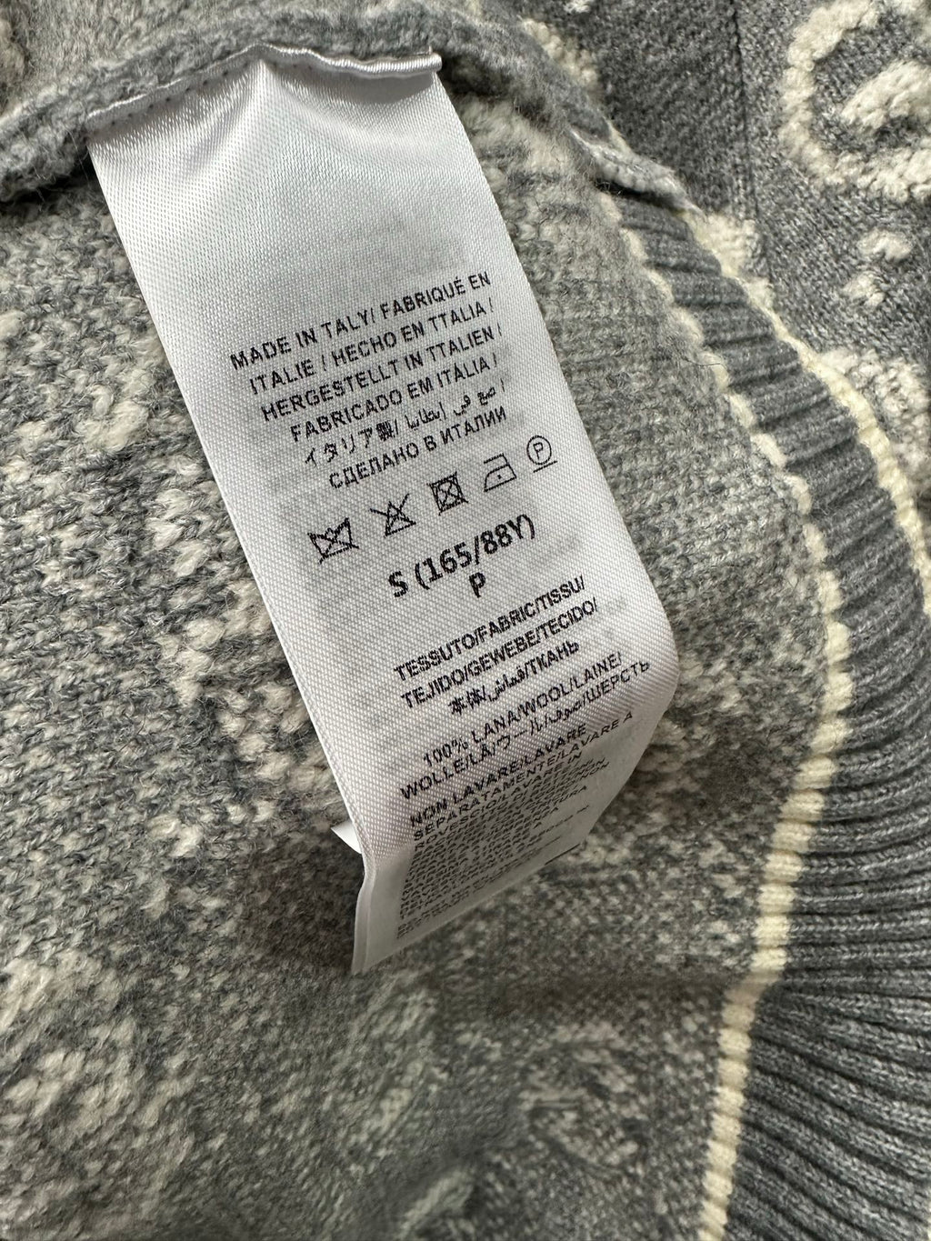 Gucci knit sweater care label tag on gray ribbed collar