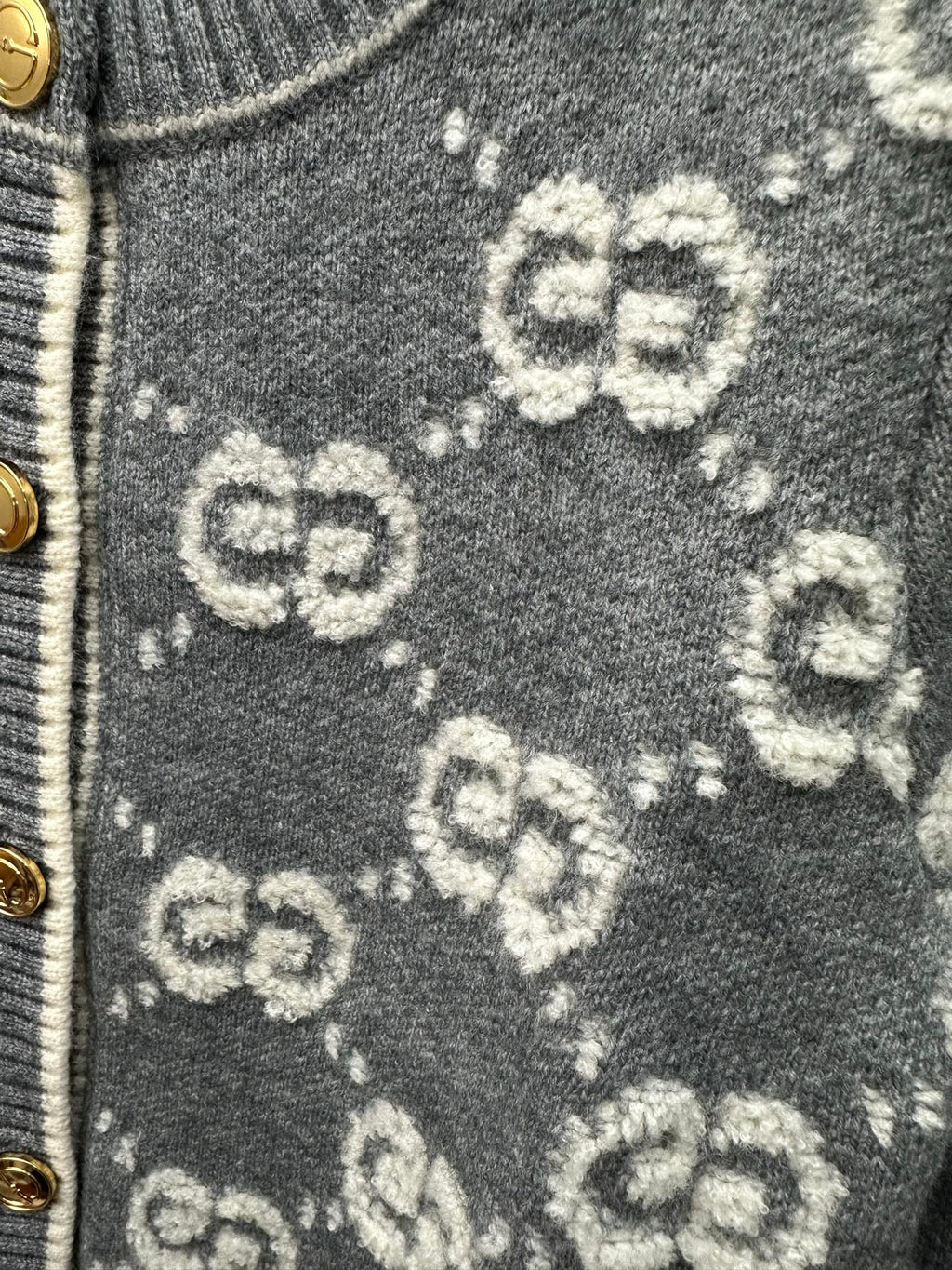 Dark green knit fabric with scattered GG monogram pattern